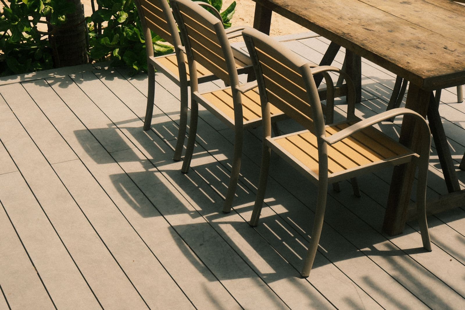 Wooden chairs and table on a sunny deck